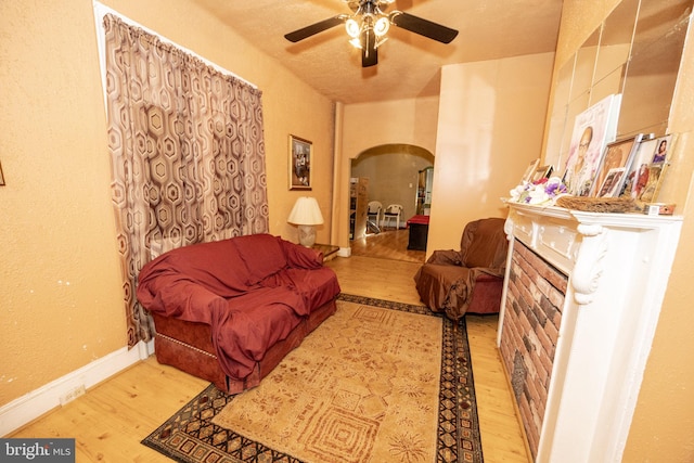 living room with ceiling fan and light wood-type flooring