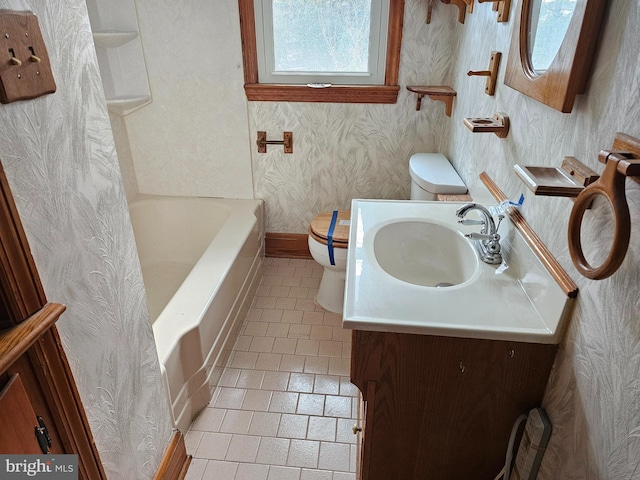 bathroom with vanity, tile patterned floors, and toilet