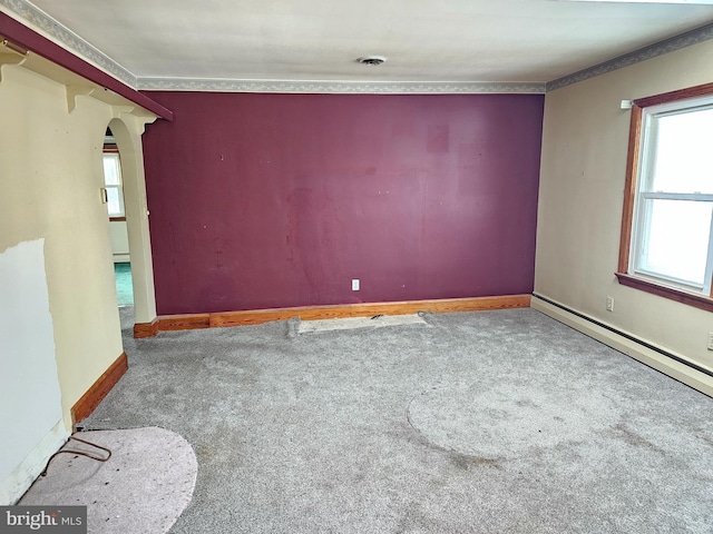 carpeted spare room featuring baseboard heating