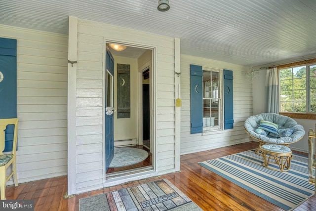 sunroom / solarium featuring baseboard heating