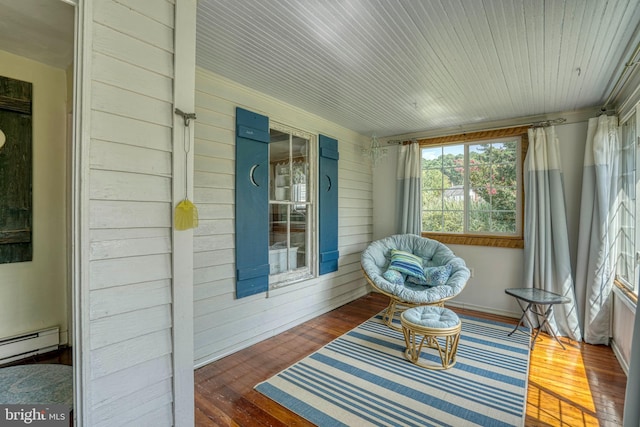 sunroom with a baseboard heating unit