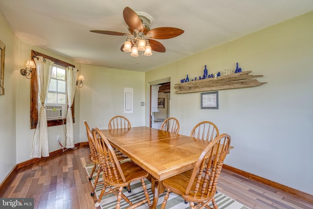 dining room with hardwood / wood-style flooring, cooling unit, and ceiling fan