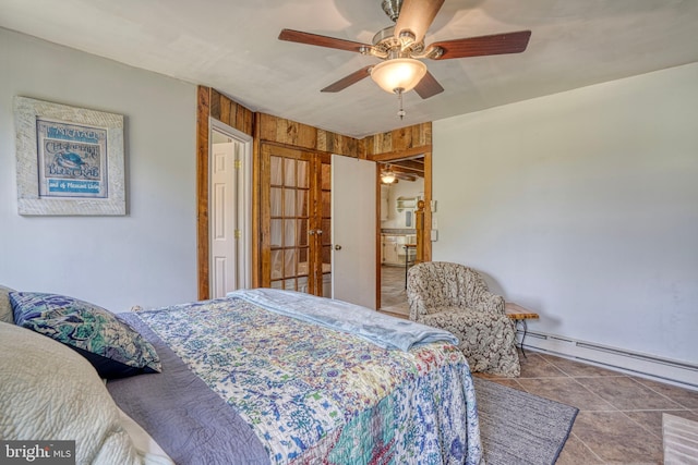 bedroom with ceiling fan, light tile patterned floors, and a baseboard heating unit