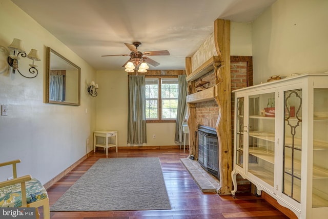 living room with ceiling fan, hardwood / wood-style floors, and a fireplace