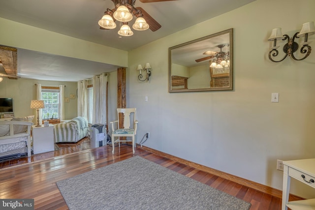 living room featuring ceiling fan and wood-type flooring