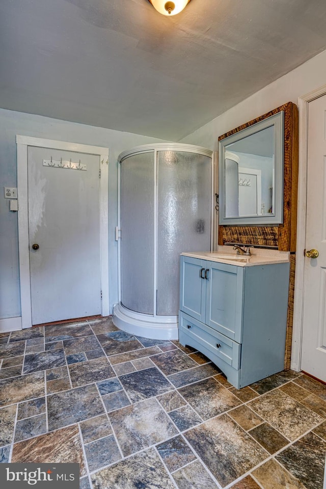 bathroom featuring vanity and an enclosed shower