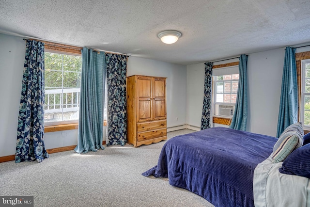 carpeted bedroom featuring a baseboard radiator, cooling unit, and a textured ceiling