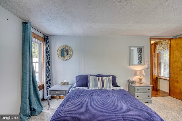 carpeted bedroom with a textured ceiling