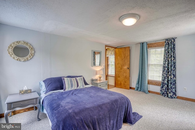 carpeted bedroom with a textured ceiling