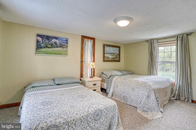 carpeted bedroom featuring a textured ceiling