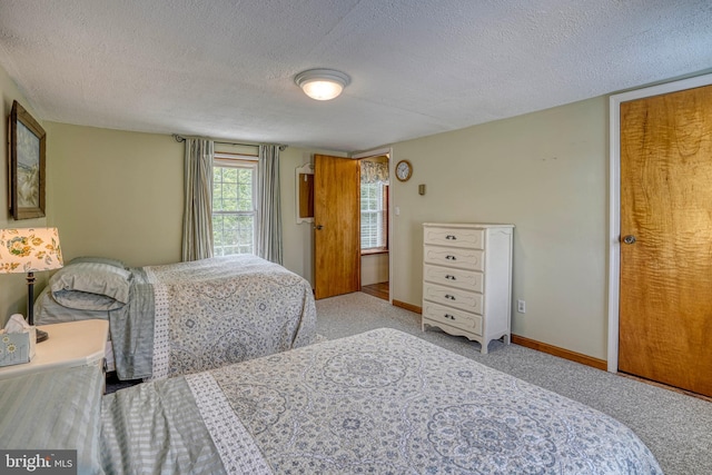 carpeted bedroom with a textured ceiling