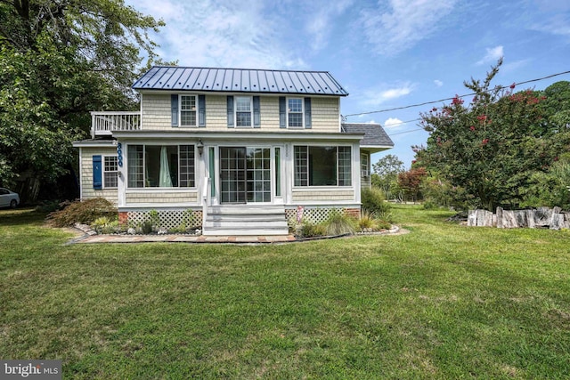 view of front facade with a sunroom and a front yard