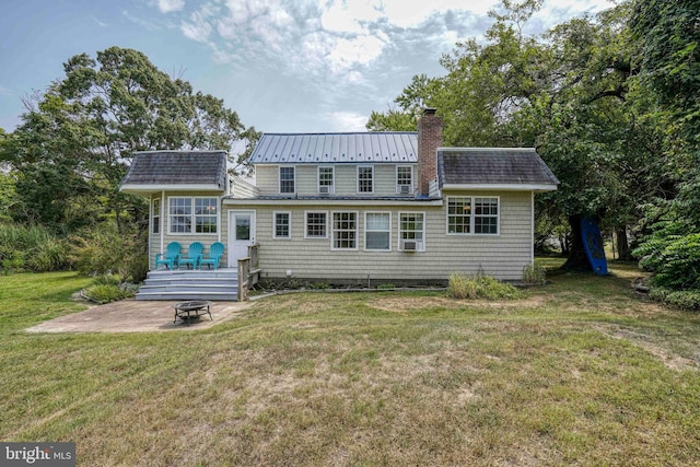 back of property featuring a patio area and a lawn