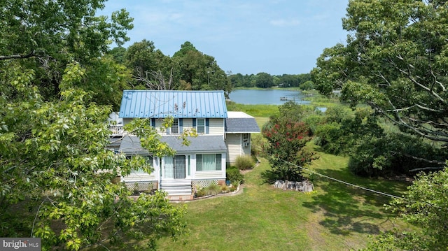 exterior space featuring a water view and a lawn