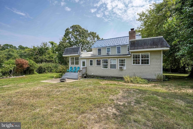 rear view of property featuring a lawn and a patio