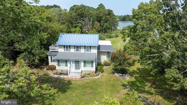 view of front of home featuring a water view and a front lawn