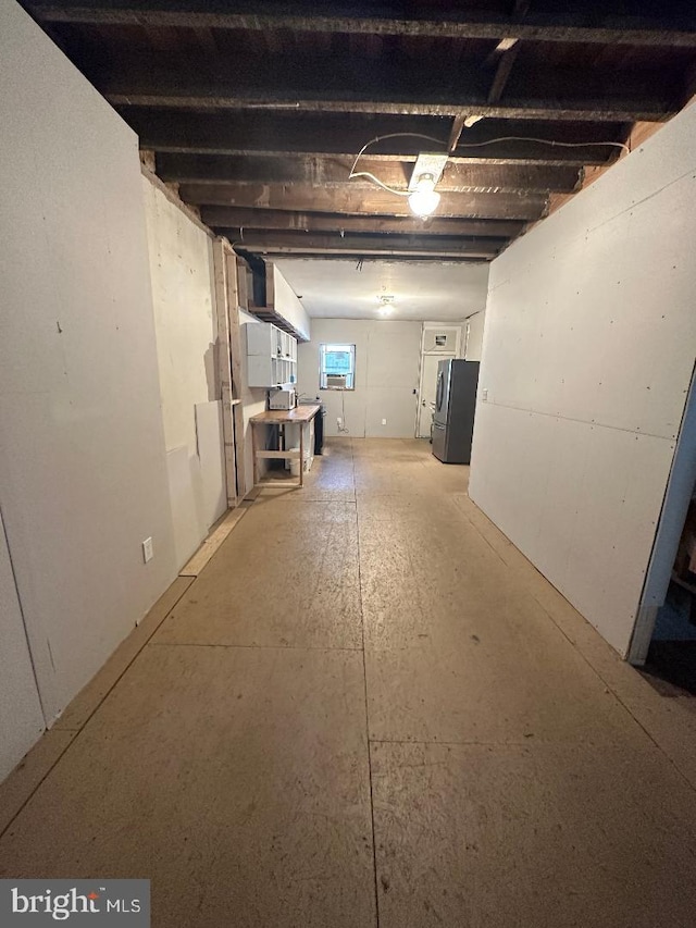 basement with stainless steel refrigerator