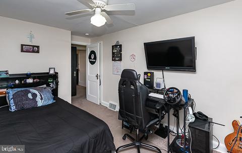 bedroom with ceiling fan and carpet floors