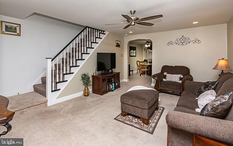 living room featuring ceiling fan and carpet floors