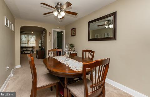 dining room featuring ceiling fan and light colored carpet