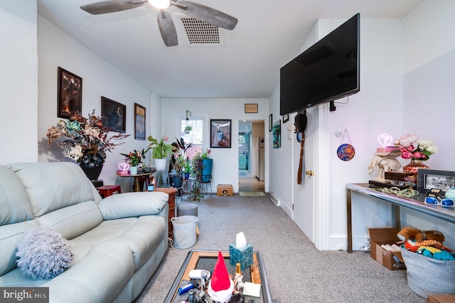 living room with ceiling fan and carpet