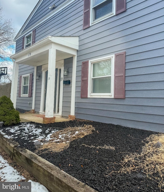 view of snow covered property entrance