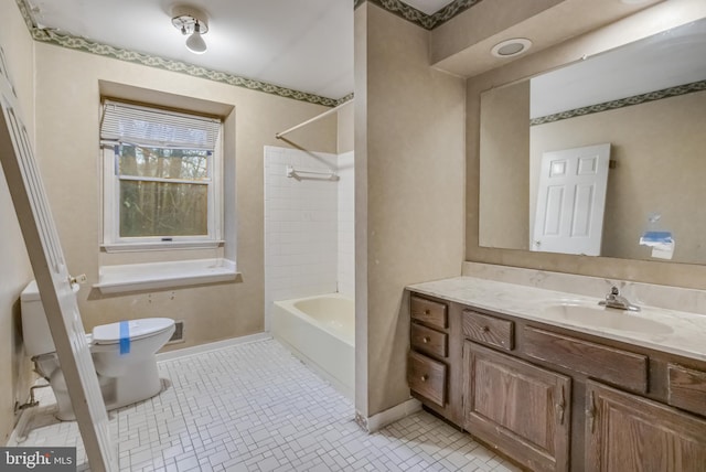 full bathroom with tile patterned flooring, vanity, tiled shower / bath combo, and toilet