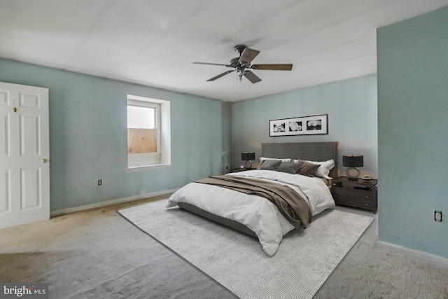 bedroom featuring light carpet and ceiling fan