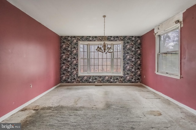 unfurnished dining area featuring carpet flooring and a chandelier