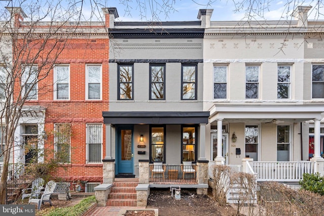 multi unit property featuring a porch and brick siding