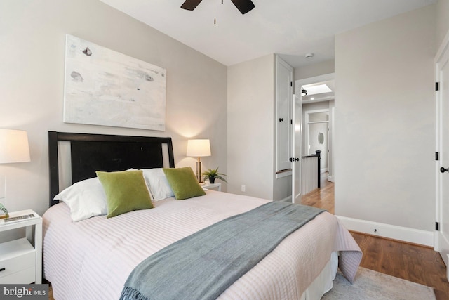 bedroom with ceiling fan and light hardwood / wood-style floors