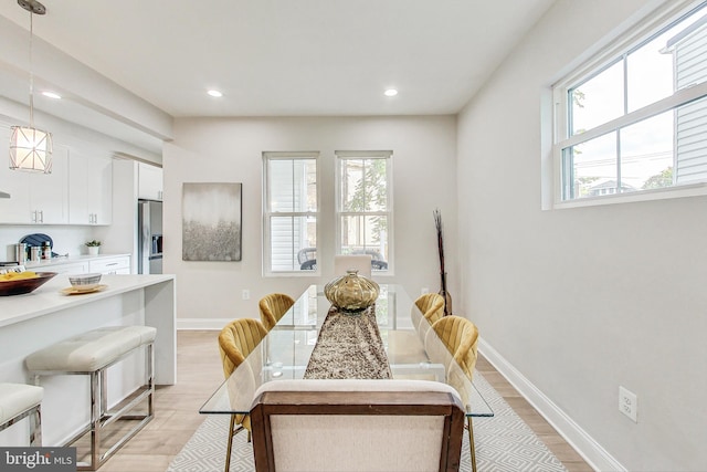 dining area with light hardwood / wood-style flooring and plenty of natural light