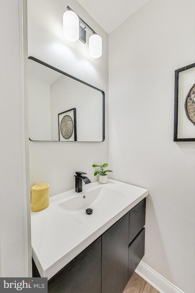 bathroom with hardwood / wood-style flooring and vanity