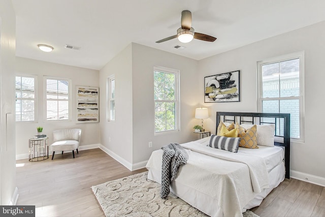 bedroom with light hardwood / wood-style floors and ceiling fan