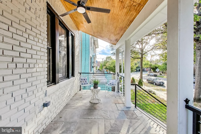 view of patio with ceiling fan and a porch