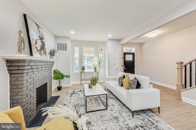 living room featuring a fireplace and light hardwood / wood-style floors