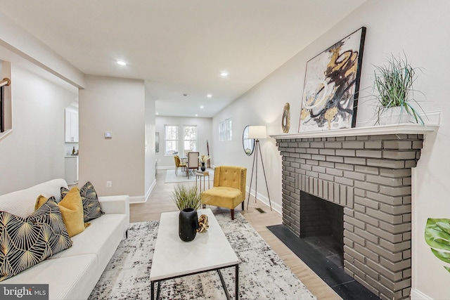 living room with a fireplace and light hardwood / wood-style flooring