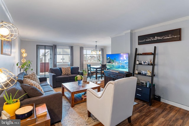 living room featuring ornamental molding, dark hardwood / wood-style flooring, and a notable chandelier