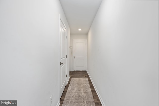 hall with dark wood-type flooring