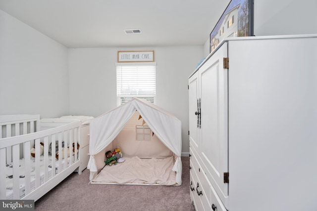 bedroom with a crib and carpet