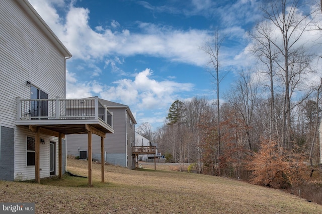 view of yard featuring cooling unit and a deck