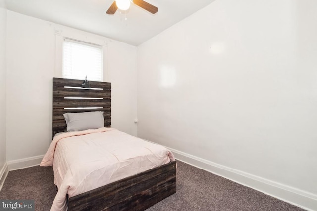 bedroom with dark colored carpet, lofted ceiling, and ceiling fan