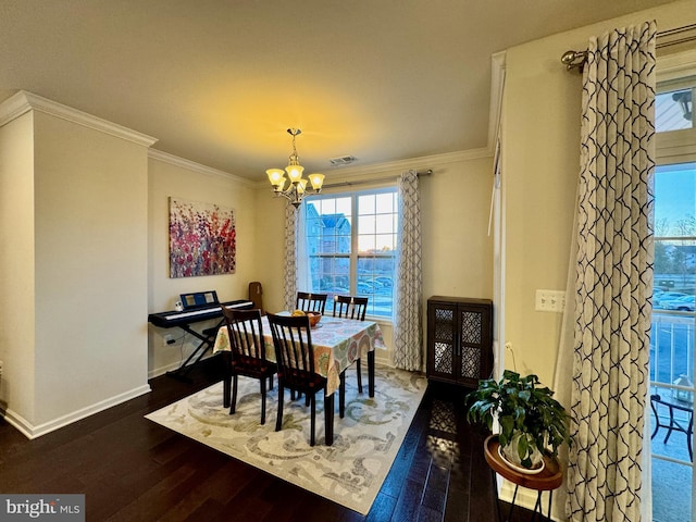 dining area with dark hardwood / wood-style flooring, crown molding, and a chandelier