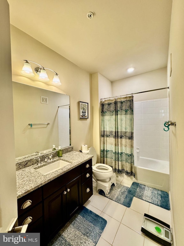 full bathroom with shower / bath combo, vanity, tile patterned floors, and toilet