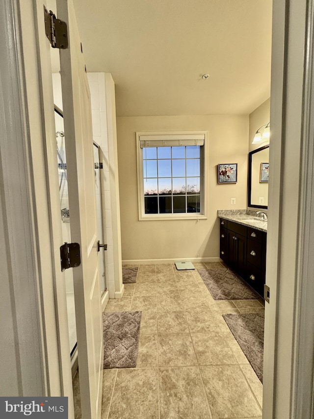 bathroom with vanity and a shower with door