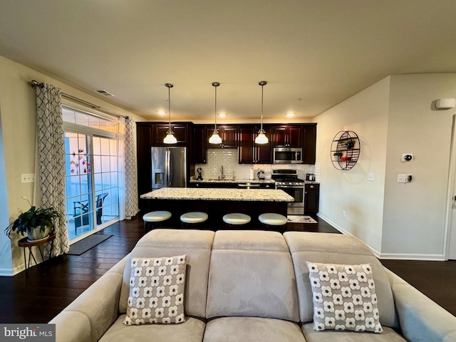 living room with sink and dark hardwood / wood-style floors