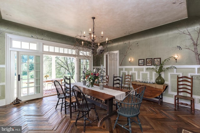 dining room featuring an inviting chandelier and dark parquet floors