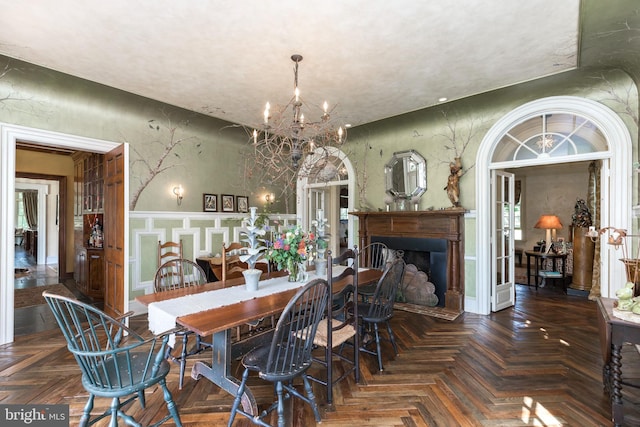 dining area with parquet floors and a notable chandelier