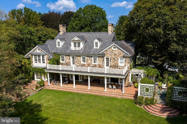 back of house featuring a patio, a yard, and a deck