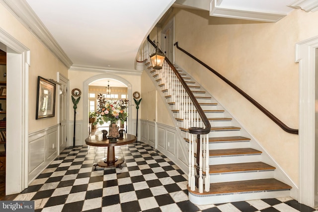 entrance foyer with a notable chandelier and ornamental molding